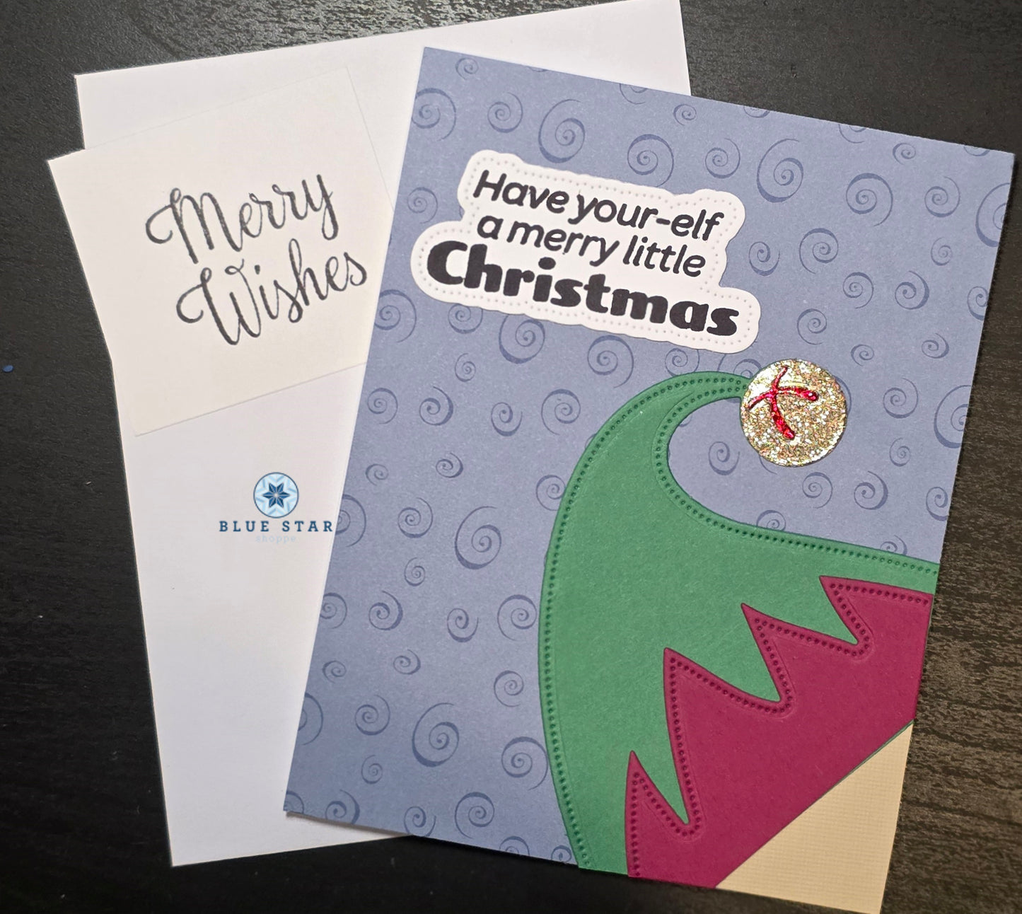 Christmas card with 'Merry Wishes' text and an elf design.