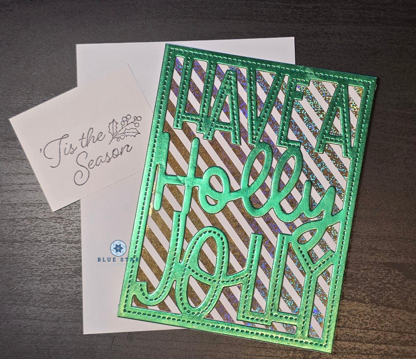Holiday card with 'Have a Holly Jolly' text on a striped background