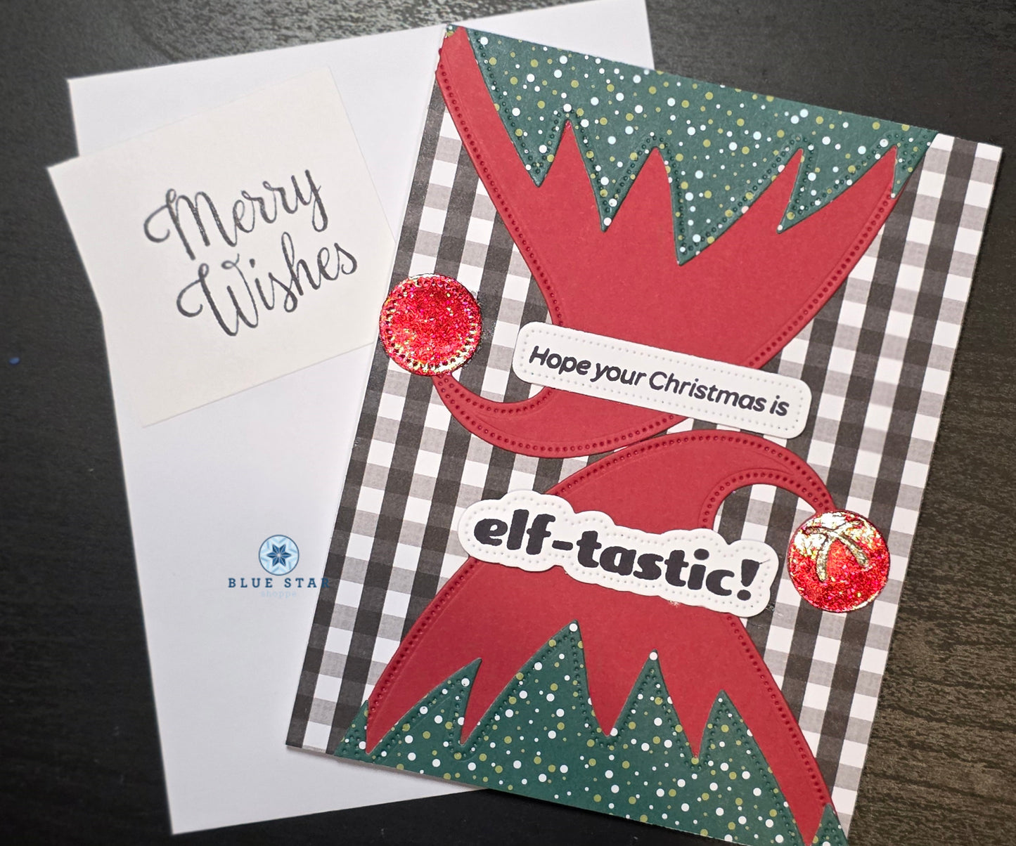 Christmas card with red elf design and text on a checkered background