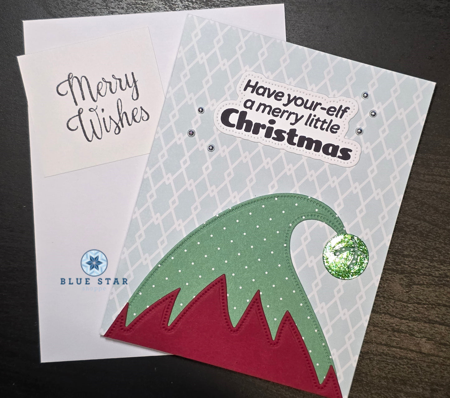 Christmas card with elf hat design and 'Have your elf a merry little Christmas' text