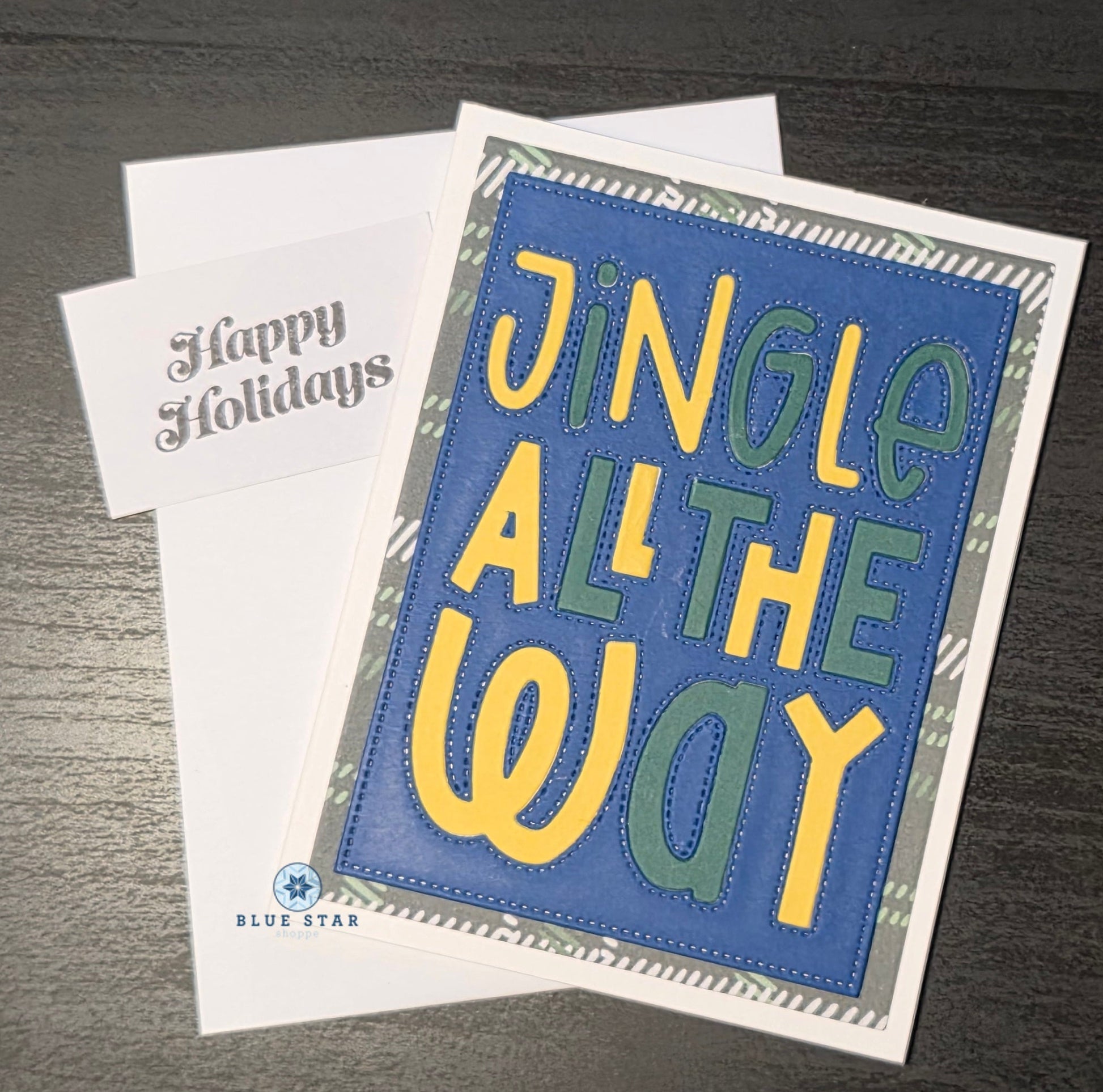 Holiday card with 'Jingle All The Way' text on a blue background