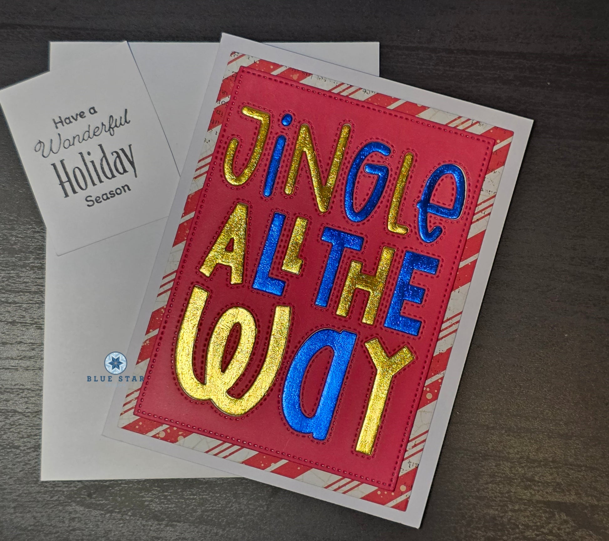 Holiday card with 'Jingle All the Way' text on a red background