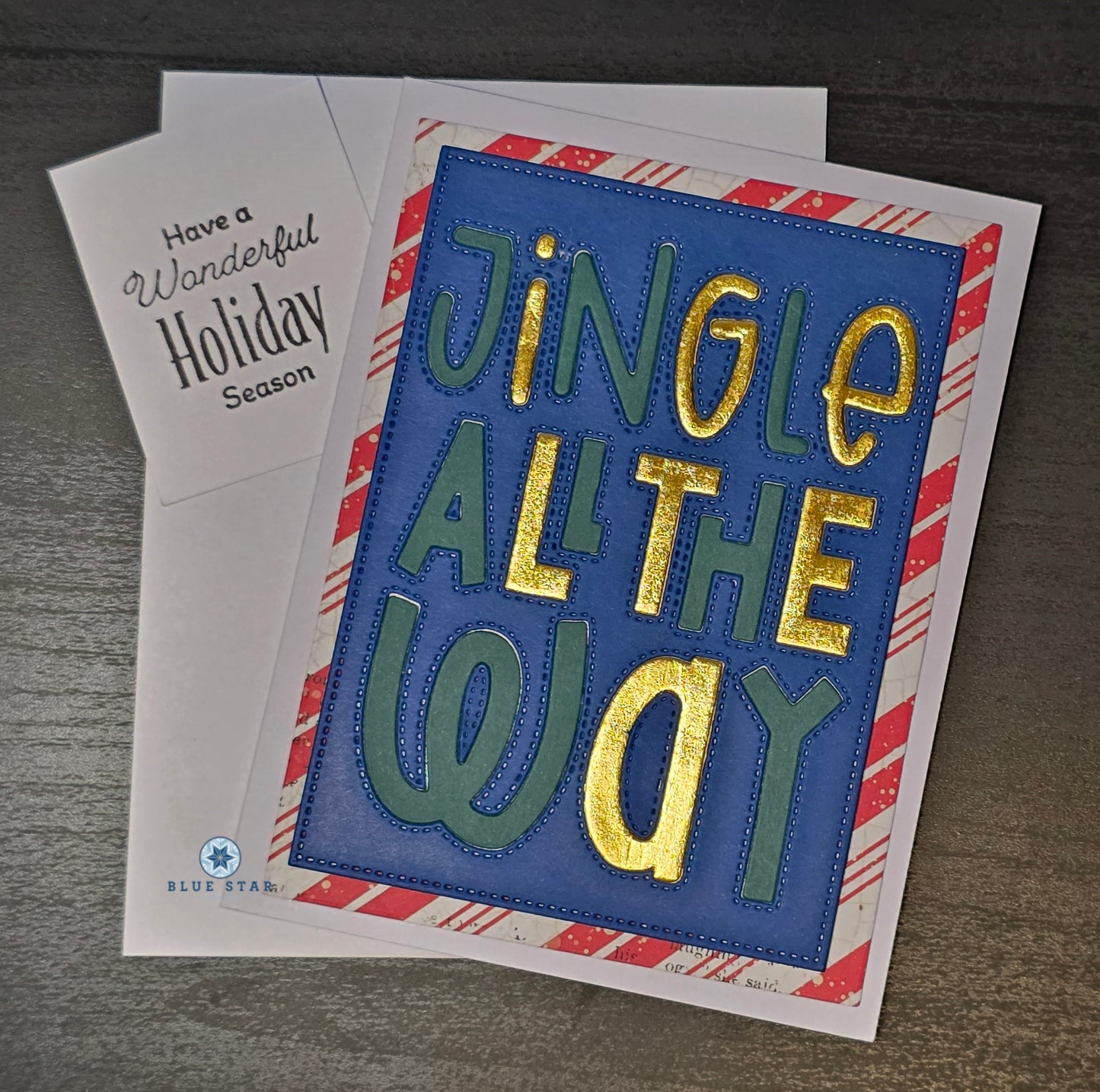 Holiday card with 'Jingle All the Way' text on a striped background