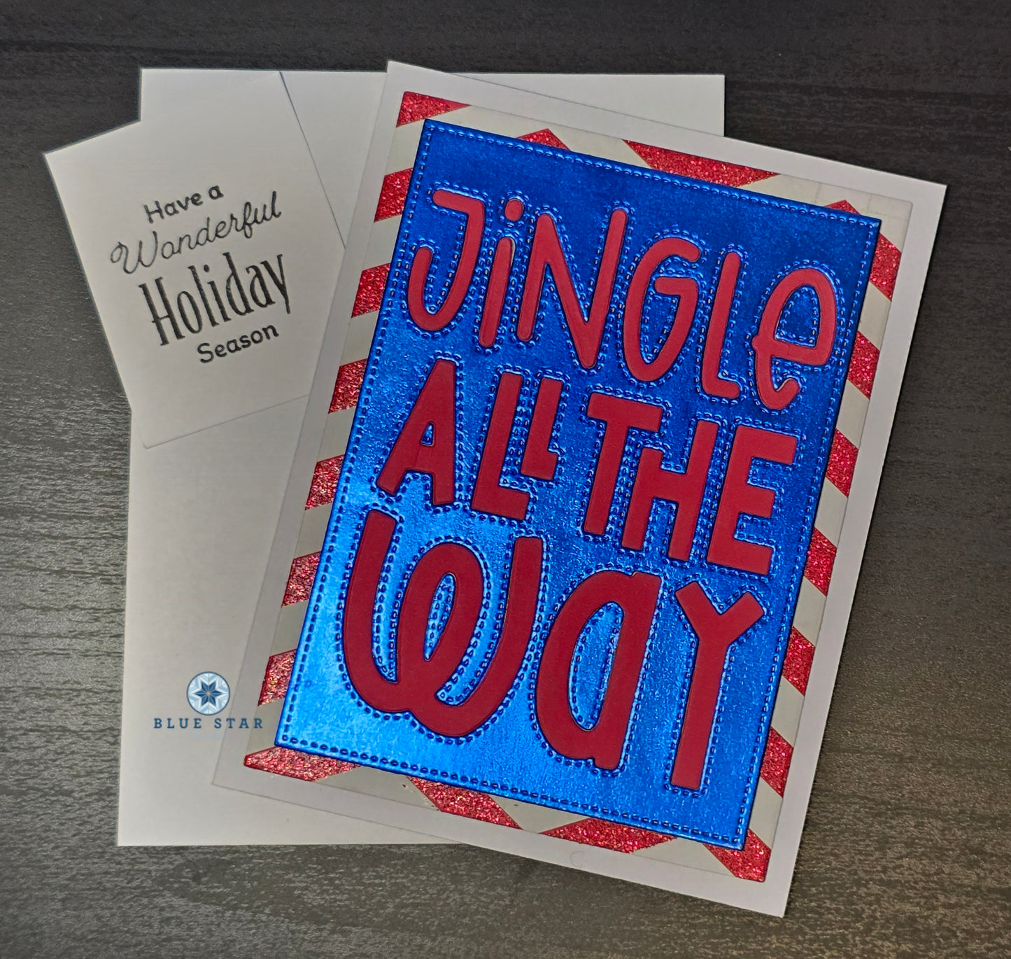 Holiday card with 'Jingle All the Way' text on a blue background