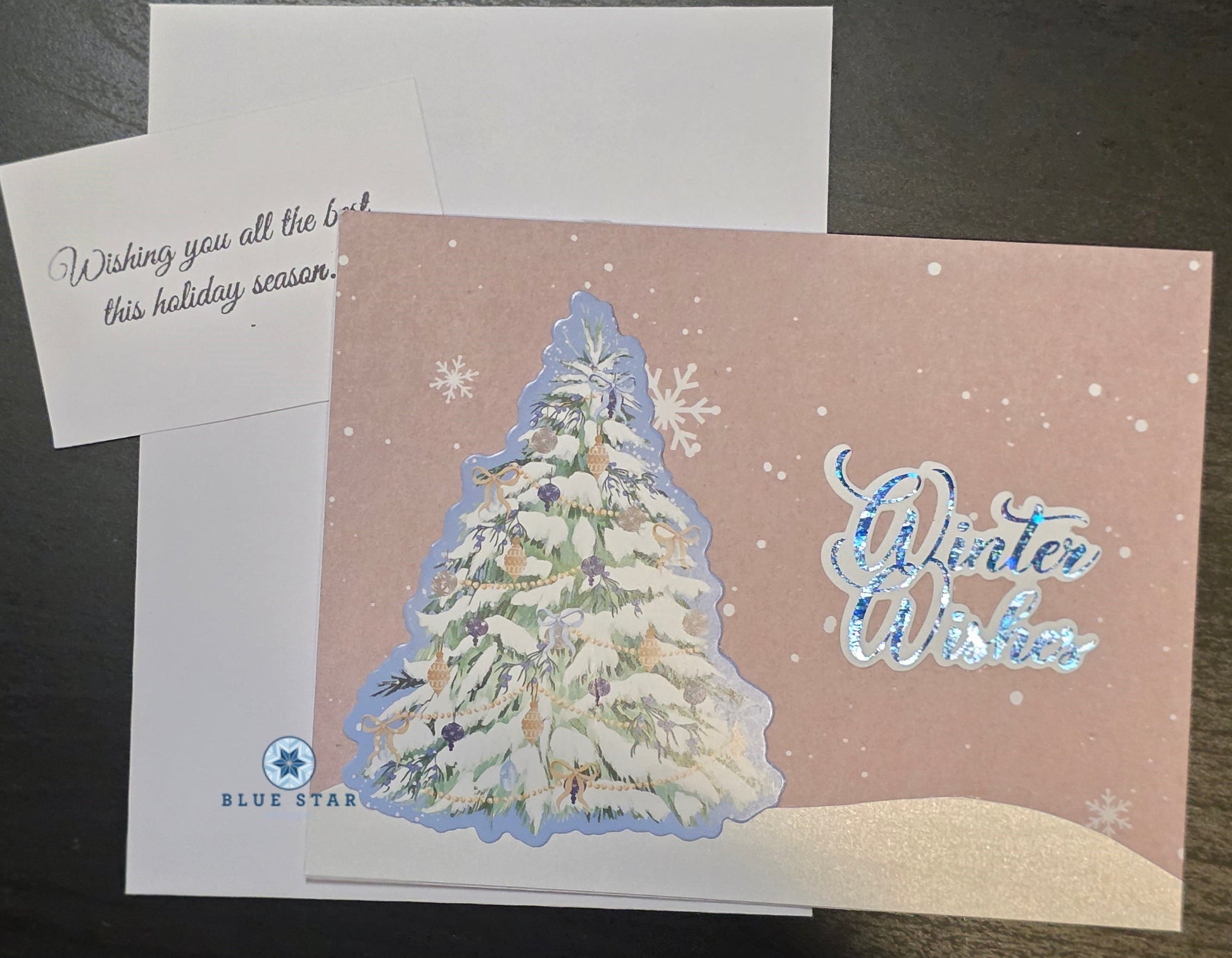 Christmas card with snowy tree design and 'Winter Wishes' text 